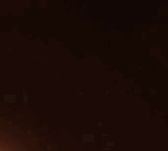 A Beam Of Light Is Shining Through A Dark Background GIF