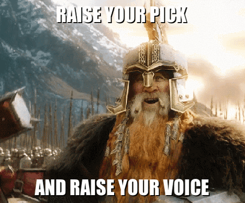 A Bearded Man Wearing A Helmet With The Words Raise Your Pick And Raise Your Voice Below Him GIF