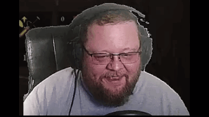 A Bearded Man Wearing Headphones And Glasses Is Sitting In A Chair . GIF