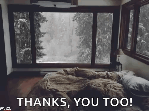 A Bed In A Bedroom With A Large Window Looking Out To A Forest . GIF