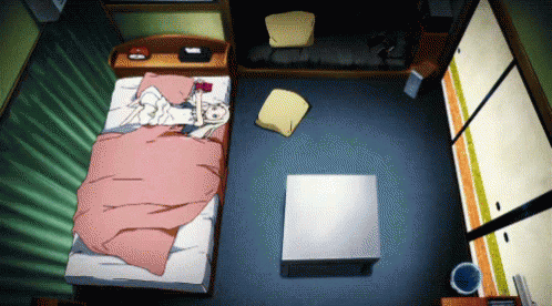 A Bedroom With A Bed And A Coffee Table And A Trash Can GIF