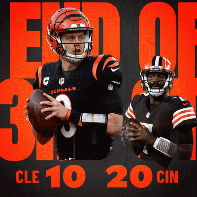 A Bengals Football Player Holding A Ball Next To Another Player GIF