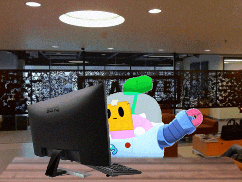 A Benq Computer Monitor With A Cartoon Character Behind It GIF