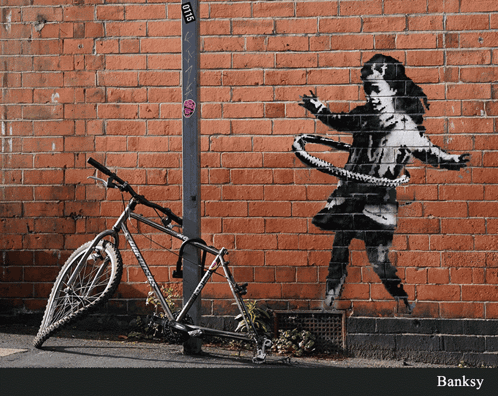 A Bicycle Is Parked In Front Of A Brick Wall With A Painting Of A Girl With A Hula Hoop GIF