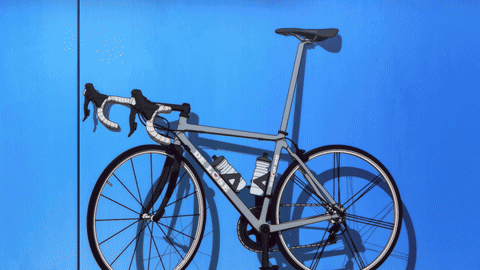 A Bicycle With A Purple Background And A Purple Glow GIF