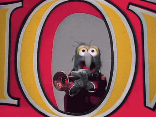 A Bird Is Playing A Trumpet In Front Of The Letter O. GIF
