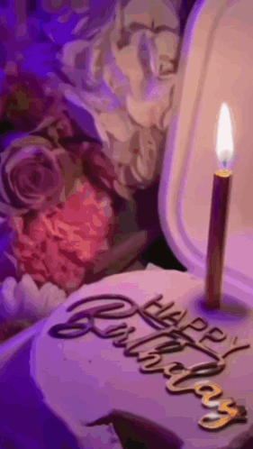 A Birthday Cake With A Candle And The Words Happy Birthday Written On It GIF