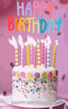A Birthday Cake With Candles And Sprinkles On It And The Words `` Happy Birthday '' Written On It . GIF
