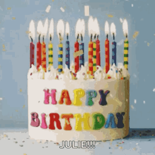 A Birthday Cake With Candles And The Words Happy Birthday Julie On It GIF