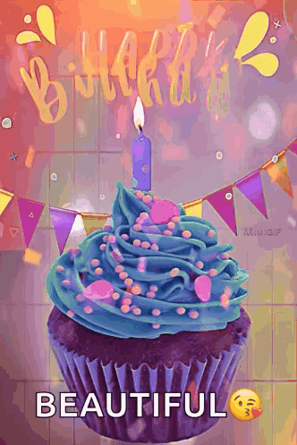 A Birthday Cupcake With Blue Frosting And Sprinkles And A Lit Candle GIF