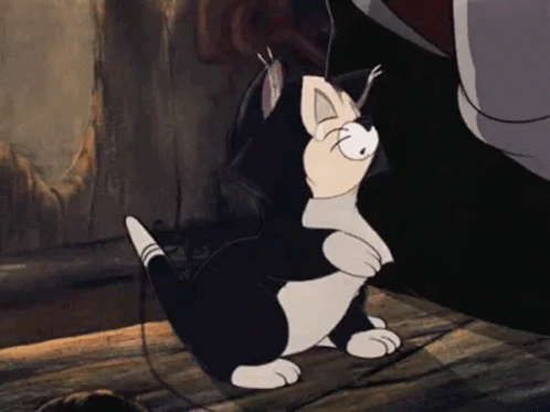 A Black And White Cartoon Cat Is Sitting On A Wooden Floor Next To A Person . GIF