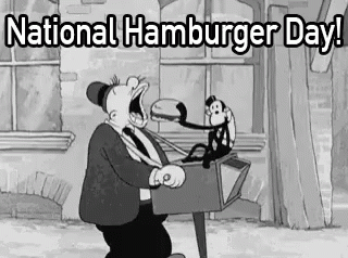 A Black And White Cartoon Of A Man Eating A Hamburger With A Monkey Sitting On A Lamp Post . GIF