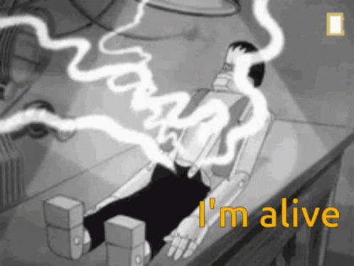 A Black And White Cartoon Of A Robot Laying On A Table With The Words I 'M Alive Above It GIF