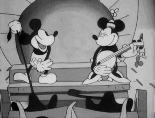 A Black And White Cartoon Of Mickey Mouse Playing A Guitar GIF