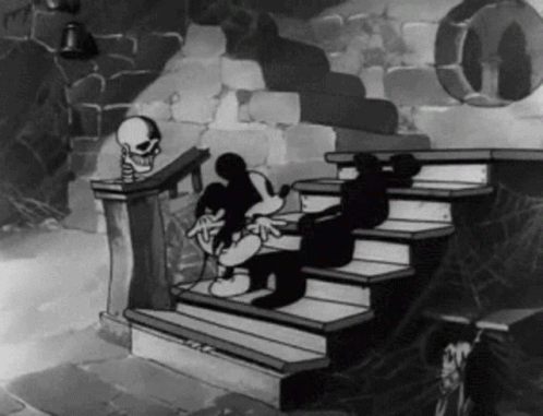 A Black And White Cartoon Of Mickey Mouse Sitting On A Set Of Stairs With A Skeleton In The Background . GIF