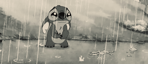 A Black And White Cartoon Of Stitch Standing In The Rain With A Sad Look On His Face GIF