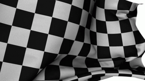 A Black And White Checkered Flag Is Being Blown In The Wind GIF