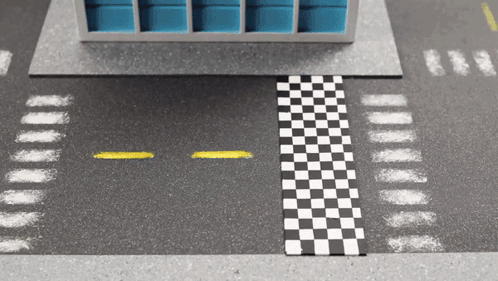 A Black And White Checkered Race Track With A Yellow Line GIF
