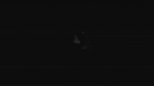 A Black And White Drawing Of A Person 'S Face With Big Eyes In The Dark . GIF