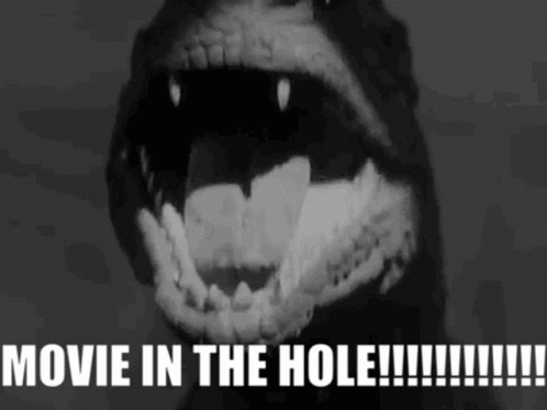 A Black And White Image Of A Monster With The Words Movie In The Hole Written Below It GIF