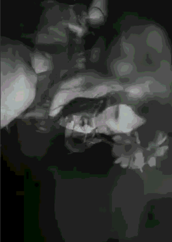 A Black And White Image Of A Person 'S Face With A Green Background GIF