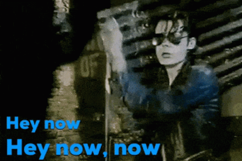 A Black And White Image Of A Person With The Words Hey Now In Blue GIF