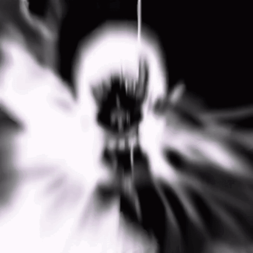 A Black And White Image Of A Skull With A Glowing Mouth And Teeth . GIF