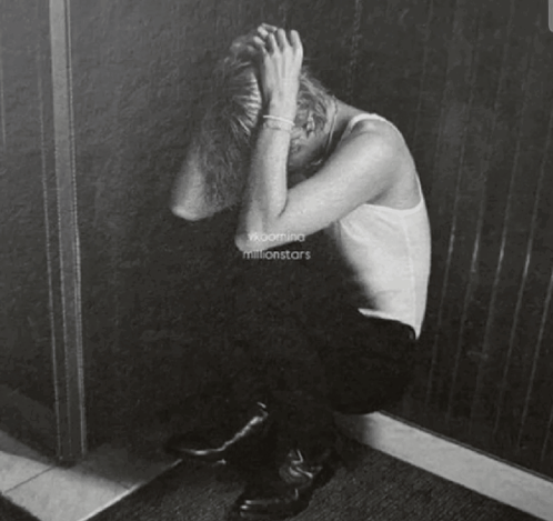 A Black And White Painting Of A Person Covering Their Face GIF