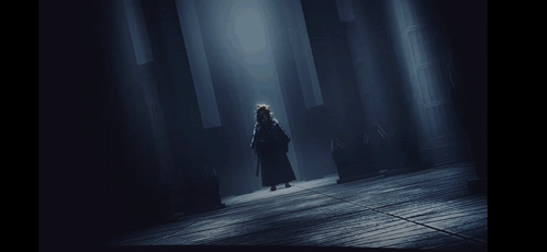 A Black And White Painting Of A Person Walking In The Dark GIF
