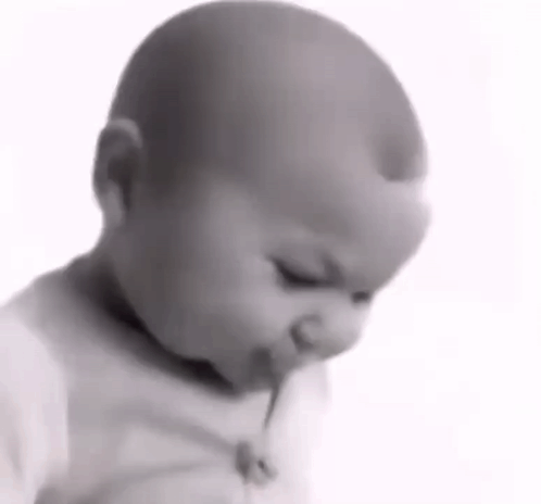 Baby Eating Lollipop In Black And White GIF
