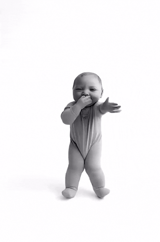 A Black And White Photo Of A Baby Standing On Its Hind Legs GIF