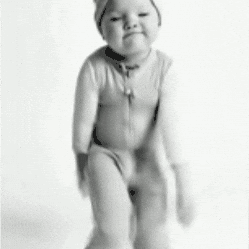 A Black And White Photo Of A Baby Wearing A Hat GIF