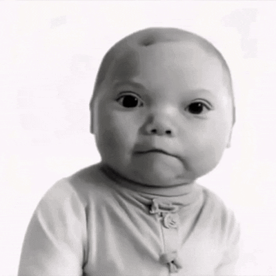 A Black And White Photo Of A Baby Wearing A Turtleneck GIF