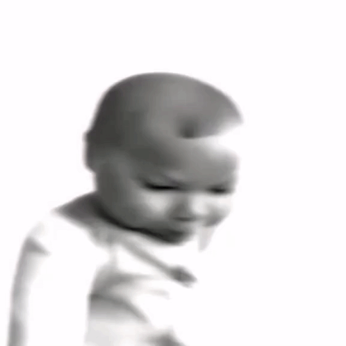 a black and white photo of a baby wearing a white shirt