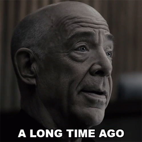 A Black And White Photo Of A Bald Man With The Words A Long Time Ago Below Him GIF