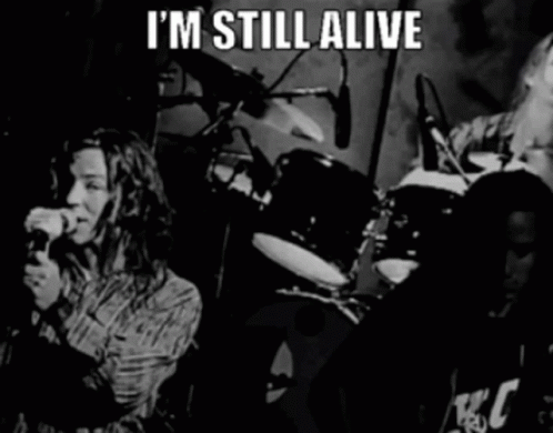 A Black And White Photo Of A Band With The Words " I 'M Still Alive " GIF
