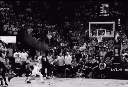 A Black And White Photo Of A Basketball Game With A Score Of 3.6 GIF