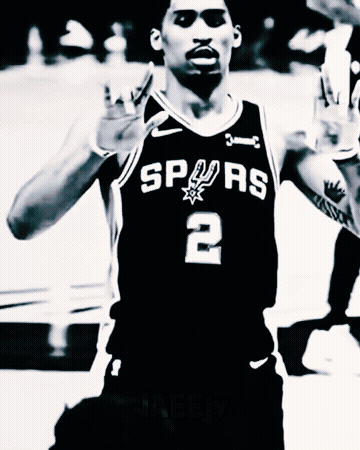 a black and white photo of a basketball player wearing a spurs jersey