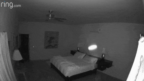 A Black And White Photo Of A Bedroom With The Website Ring.com GIF