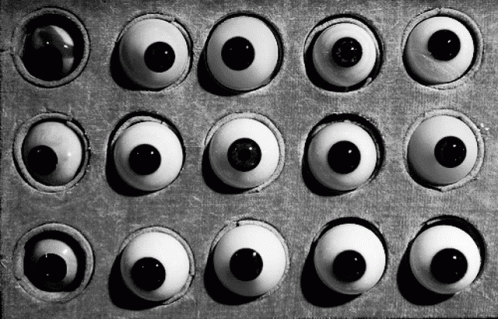 A Black And White Photo Of A Box Of Eyes GIF