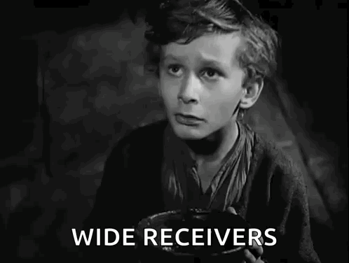A Black And White Photo Of A Boy Holding A Bowl That Says I Want Some More GIF