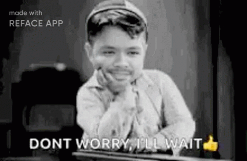 A Black And White Photo Of A Boy Sitting At A Table With His Hand On His Chin And A Thumbs Up . GIF