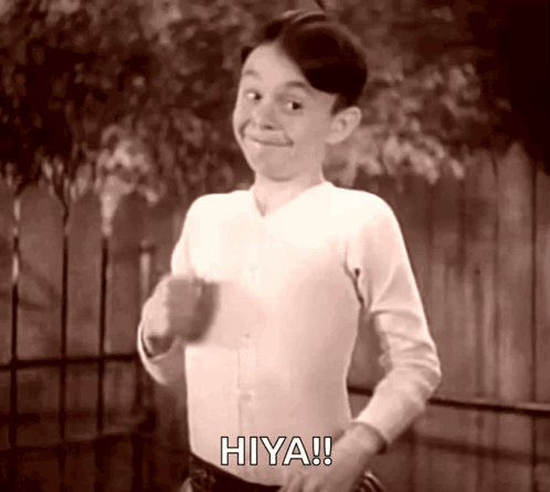 A Black And White Photo Of A Boy With The Word Hiya On His Shirt GIF