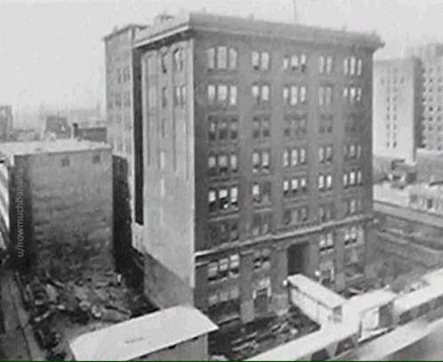 A Black And White Photo Of A Building With A Lot Of Windows GIF