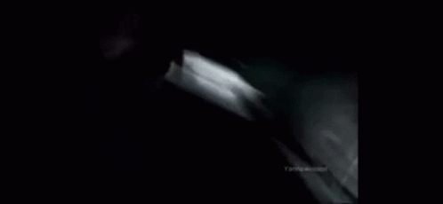 A Black And White Photo Of A Car Going Down A Hill GIF