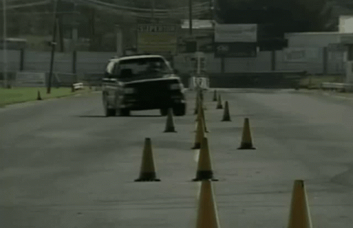 A Black And White Photo Of A Car On A Road GIF