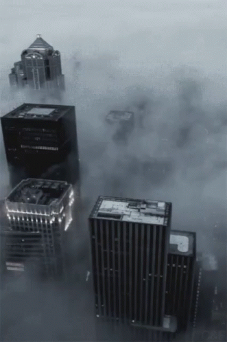 A Black And White Photo Of A City With A Lot Of Buildings GIF