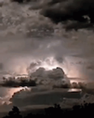 A Black And White Photo Of A Cloudy Sky With Lightning GIF