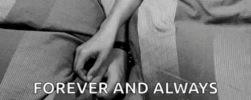 A Black And White Photo Of A Couple Holding Hands . GIF