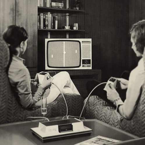 A Black And White Photo Of A Couple Playing A Game On A Commodore GIF